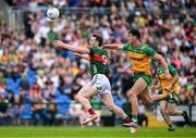 15 June 2025; Matthew Ruane of Mayo in action against Michael Langan of Donegal during the GAA Football All-Ireland Senior Championship Round 3 match between Donegal and Mayo at King & Moffatt Dr Hyde Park in Roscommon. Photo by Seb Daly/Sportsfile