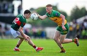15 June 2025; Oisin Gallen of Donegal in action against Jack Coyne of Mayo during the GAA Football All-Ireland Senior Championship Round 3 match between Donegal and Mayo at King & Moffatt Dr Hyde Park in Roscommon. Photo by Seb Daly/Sportsfile
