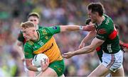 15 June 2025; Oisin Gallen of Donegal in action against Matthew Ruane of Mayo during the GAA Football All-Ireland Senior Championship Round 3 match between Donegal and Mayo at King & Moffatt Dr Hyde Park in Roscommon. Photo by Seb Daly/Sportsfile