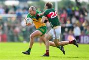 15 June 2025; Michael Murphy of Donegal in action against Donnacha McHugh of Mayo during the GAA Football All-Ireland Senior Championship Round 3 match between Donegal and Mayo at King & Moffatt Dr Hyde Park in Roscommon. Photo by Seb Daly/Sportsfile