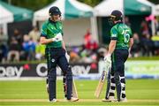 15 June 2025; Ireland batters Harry Tector, left, and Ross Adair during match three of the T20 International Series between Ireland and the West Indies at Bready Cricket Club in Magheramason, Tyrone. Photo by Ramsey Cardy/Sportsfile