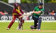 15 June 2025; Ireland batter Harry Tector and West Indies wicketkeeper Shai Hope during match three of the T20 International Series between Ireland and the West Indies at Bready Cricket Club in Magheramason, Tyrone. Photo by Ramsey Cardy/Sportsfile