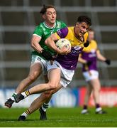 15 June 2025; Páiric Hughes of Wexford is tackled by Peter Nash of Limerick during the Tailteann Cup quarter-final match between Limerick and Wexford at TUS Gaelic Grounds in Limerick. Photo by Tom Beary/Sportsfile