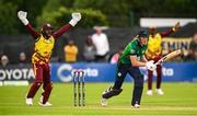 15 June 2025; Ireland batter Harry Tector is bowled leg before wicket by West Indies bowler Roston Chase during match three of the T20 International Series between Ireland and the West Indies at Bready Cricket Club in Magheramason, Tyrone. Photo by Ramsey Cardy/Sportsfile