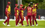 15 June 2025; West Indies players celebrate taking the wicket of Ross Adair of Ireland during match three of the T20 International Series between Ireland and the West Indies at Bready Cricket Club in Magheramason, Tyrone. Photo by Ramsey Cardy/Sportsfile