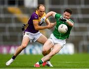 15 June 2025; Darren O'Doherty of Limerick is tackled by Sean Ryan of Wexford during the Tailteann Cup quarter-final match between Limerick and Wexford at TUS Gaelic Grounds in Limerick. Photo by Tom Beary/Sportsfile
