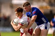 15 June 2025; Conor Meyler of Tyrone is tackled by Paddy Lynch of Cavan during the GAA Football All-Ireland Senior Championship Round 3 match between Tyrone and Cavan at Brewster Park in Enniskillen, Fermanagh. Photo by Ben McShane/Sportsfile