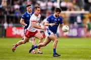 15 June 2025; Sean McEvoy of Cavan in action against Kieran McGeary of Tyrone during the GAA Football All-Ireland Senior Championship Round 3 match between Tyrone and Cavan at Brewster Park in Enniskillen, Fermanagh. Photo by Ben McShane/Sportsfile