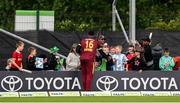 15 June 2025; Romario Shepherd of West Indies signs autographs during match three of the T20 International Series between Ireland and the West Indies at Bready Cricket Club in Magheramason, Tyrone. Photo by Ramsey Cardy/Sportsfile
