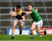 15 June 2025; Páiric Hughes of Wexford is tackled by Peter Nash of Limerick during the Tailteann Cup quarter-final match between Limerick and Wexford at TUS Gaelic Grounds in Limerick. Photo by Tom Beary/Sportsfile