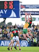 15 June 2025; Ciaran Thompson of Donegal in action against Jordan Flynn of Mayo during the GAA Football All-Ireland Senior Championship Round 3 match between Donegal and Mayo at King & Moffatt Dr Hyde Park in Roscommon. Photo by Seb Daly/Sportsfile