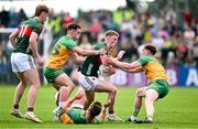 15 June 2025; David McBrien of Mayo in action against Caolan McColgan, left, and Ciaran Thompson of Donegal during the GAA Football All-Ireland Senior Championship Round 3 match between Donegal and Mayo at King & Moffatt Dr Hyde Park in Roscommon. Photo by Seb Daly/Sportsfile