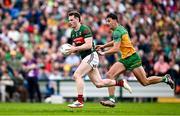 15 June 2025; Matthew Ruane of Mayo in action against Michael Langan of Donegal during the GAA Football All-Ireland Senior Championship Round 3 match between Donegal and Mayo at King & Moffatt Dr Hyde Park in Roscommon. Photo by Seb Daly/Sportsfile