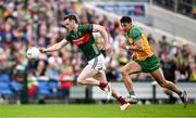 15 June 2025; Matthew Ruane of Mayo in action against Michael Langan of Donegal during the GAA Football All-Ireland Senior Championship Round 3 match between Donegal and Mayo at King & Moffatt Dr Hyde Park in Roscommon. Photo by Seb Daly/Sportsfile