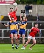 15 June 2025; Dara McDonnell of Louth contests a high ball against Louth players Emmet McMahon, left, and Mark McInerney during the GAA Football All-Ireland Senior Championship Round 3 match between Louth and Clare at Laois Hire O'Moore Park in Portlaoise, Laois. Photo by Shauna Clinton/Sportsfile