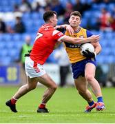 15 June 2025; Ronan Lanigan of Clare is tackled by Craig Lennon of Louth during the GAA Football All-Ireland Senior Championship Round 3 match between Louth and Clare at Laois Hire O'Moore Park in Portlaoise, Laois. Photo by Shauna Clinton/Sportsfile