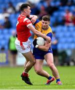 15 June 2025; Ronan Lanigan of Clare is tackled by Craig Lennon of Louth during the GAA Football All-Ireland Senior Championship Round 3 match between Louth and Clare at Laois Hire O'Moore Park in Portlaoise, Laois. Photo by Shauna Clinton/Sportsfile