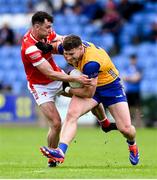 15 June 2025; Ronan Lanigan of Clare is tackled by Craig Lennon of Louth during the GAA Football All-Ireland Senior Championship Round 3 match between Louth and Clare at Laois Hire O'Moore Park in Portlaoise, Laois. Photo by Shauna Clinton/Sportsfile