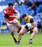 15 June 2025; Ronan Lanigan of Clare is tackled by Craig Lennon of Louth during the GAA Football All-Ireland Senior Championship Round 3 match between Louth and Clare at Laois Hire O'Moore Park in Portlaoise, Laois. Photo by Shauna Clinton/Sportsfile