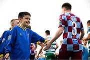 16 June 2025; A mascot gives Conor Kane of Drogheda United a high five before the SSE Airtricity Men's Premier Division match between Drogheda United and Shamrock Rovers at Sullivan & Lambe Park in Drogheda, Louth. Photo by Shauna Clinton/Sportsfile