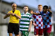 16 June 2025; Referee Neil Doyle looks on as Thomas Oluwa of Drogheda United remonstrates a decision during the SSE Airtricity Men's Premier Division match between Drogheda United and Shamrock Rovers at Sullivan & Lambe Park in Drogheda, Louth. Photo by Ben McShane/Sportsfile