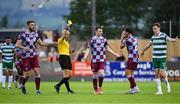 16 June 2025; Referee Neil Doyle shows Luke Heeney of Drogheda United a yellow card during the SSE Airtricity Men's Premier Division match between Drogheda United and Shamrock Rovers at Sullivan & Lambe Park in Drogheda, Louth. Photo by Shauna Clinton/Sportsfile