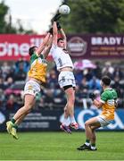 14 June 2025; David Hyland of Kildare in action against Jack McEvoy of Offaly during the Tailteann Cup quarter-final match between Kildare and Offaly at Cedral St Conleth's Park in Newbridge, Kildare. Photo by Piaras Ó Mídheach/Sportsfile