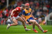 15 June 2025; Niall Doyle of Clare in action against Sam Ring of Cork during the Electric Ireland GAA Hurling All-Ireland Minor Championship semi-final match between Cork and Clare at FBD Semple Stadium in Thurles, Tipperary. Photo by Brendan Moran/Sportsfile