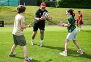20 June 2025; Andrew Porter with Tommy Morgan and Holly Williams during a British & Irish Lions community engagement event with pupils from Moorefields Primary school in Antrim, St Colombia's National School in Dublin, Clerigan National School in Tipperary and St Brendan's National School in Galway at UCD Bowl in Dublin. Photo by Brendan Moran/Sportsfile