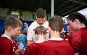 20 June 2025; Joe McCarthy signs autographs during a British & Irish Lions community engagement event with pupils from Moorefields Primary school in Antrim, St Colombia's National School in Dublin, Clerigan National School in Tipperary and St Brendan's National School in Galway at UCD Bowl in Dublin. Photo by Brendan Moran/Sportsfile