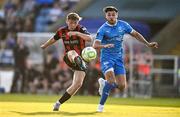 20 June 2025; Rhys Brennan of Bohemians has a shot on goal despite the attention of Grant Horton of Waterford during the SSE Airtricity Men's Premier Division match between Waterford and Bohemians at the Regional Sports Centre in Waterford. Photo by Ben McShane/Sportsfile