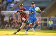 20 June 2025; Rhys Brennan of Bohemians has a shot on goal despite the attention of Grant Horton of Waterford during the SSE Airtricity Men's Premier Division match between Waterford and Bohemians at the Regional Sports Centre in Waterford. Photo by Ben McShane/Sportsfile