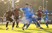 20 June 2025; Jesse Dempsey of Waterford clears from Ross Tierney of Bohemians during the SSE Airtricity Men's Premier Division match between Waterford and Bohemians at the Regional Sports Centre in Waterford. Photo by Ben McShane/Sportsfile