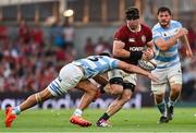 20 June 2025; Tom Curry of British & Irish Lions is tackled by Lucio Cinti of Argentina during the Lions 1888 Cup match between the British & Irish Lions and Argentina at the Aviva Stadium in Dublin. Photo by Ramsey Cardy/Sportsfile