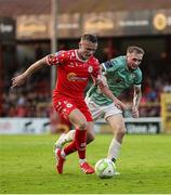 20 June 2025; JJ Lunney of Shelbourne in action against Carl Winchester during the SSE Airtricity Men's Premier Division match between Shelbourne and Derry City at Tolka Park in Dublin. Photo by Thomas Flinkow/Sportsfile