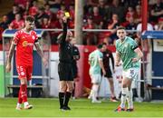 20 June 2025; Referee Neil Doyle shows a yellow card to Hayden Cann of Derry City during the SSE Airtricity Men's Premier Division match between Shelbourne and Derry City at Tolka Park in Dublin. Photo by Thomas Flinkow/Sportsfile