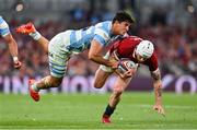 20 June 2025; Mack Hansen of British & Irish Lions is tackled by Lucio Cinti of Argentina during the Lions 1888 Cup match between the British & Irish Lions and Argentina at the Aviva Stadium in Dublin. Photo by Ramsey Cardy/Sportsfile