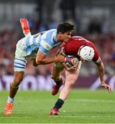 20 June 2025; Mack Hansen of British & Irish Lions is tackled by Lucio Cinti of Argentina during the Lions 1888 Cup match between the British & Irish Lions and Argentina at the Aviva Stadium in Dublin. Photo by Ramsey Cardy/Sportsfile