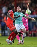 20 June 2025; Mipo Odubeko of Shelbourne attempts a shot on goal despite the efforts of Mark Connolly of Derry City and goalkeeper Brian Maher during the SSE Airtricity Men's Premier Division match between Shelbourne and Derry City at Tolka Park in Dublin. Photo by Thomas Flinkow/Sportsfile