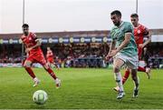 20 June 2025; Michael Duffy of Derry City in action against Shelbourne players, from left, Ellis Chapman and Daniel Kelly during the SSE Airtricity Men's Premier Division match between Shelbourne and Derry City at Tolka Park in Dublin. Photo by Thomas Flinkow/Sportsfile