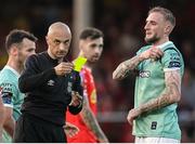 20 June 2025; Referee Neil Doyle shows a yellow card to Carl Winchester of Derry City, right, during the SSE Airtricity Men's Premier Division match between Shelbourne and Derry City at Tolka Park in Dublin. Photo by Thomas Flinkow/Sportsfile