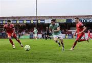 20 June 2025; Michael Duffy of Derry City in action against Shelbourne players, from left, Ellis Chapman and Daniel Kelly during the SSE Airtricity Men's Premier Division match between Shelbourne and Derry City at Tolka Park in Dublin. Photo by Thomas Flinkow/Sportsfile