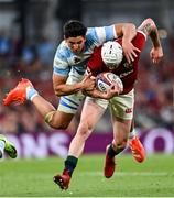 20 June 2025; Mack Hansen of British & Irish Lions is tackled by Lucio Cinti of Argentina during the Lions 1888 Cup match between the British & Irish Lions and Argentina at the Aviva Stadium in Dublin. Photo by Ramsey Cardy/Sportsfile