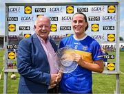 21 June 2025; Laura Morrissey of Tipperary is presented with the Player of the Match award by former LGFA President Pat Quill after the TG4 All-Ireland Ladies Football Senior Championship Group 1 match between Tipperary and Donegal at Canon Hayes Park in Bansha, Tipperary. Photo by Seb Daly/Sportsfile