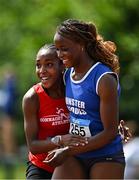 21 June 2025; Destiny Lawal of Castletroy College, representing Munster, right, celebrates with Michelle Nnadi of Dominican College Taylors Hill, representing Connacht, after winning the women's 100m during the 123.ie Irish Schools Athletics Association Tailteann Games at SETU Campus in Carlow. Photo by Sam Barnes/Sportsfile