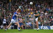 21 June 2025; David Clifford of Kerry kicks a point despite the efforts of Jason McLoughlin of Cavan during the GAA Football All-Ireland Senior Championship preliminary quarter-final match between Kerry and Cavan at Fitzgerald Stadium in Killarney, Kerry. Photo by Brendan Moran/Sportsfile