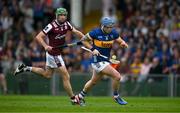 21 June 2025; Willie Connors of Tipperary in action against David Burke of Galway during the GAA Hurling All-Ireland Senior Championship quarter-final match between Galway and Tipperary at TUS Gaelic Grounds in Limerick. Photo by Ray McManus/Sportsfile
