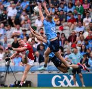 21 June 2025; Brian Hurley of Cork under pressure from Ciaran Kilkenny and David Byrne of Dublin during the GAA Football All-Ireland Senior Championship preliminary quarter-final match between Dublin and Cork at Croke Park in Dublin. Photo by Ramsey Cardy/Sportsfile