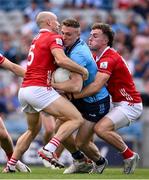 21 June 2025; Paddy Small of Dublin in action against Brian O'Driscoll, left, and Neil Lordan of Cork during the GAA Football All-Ireland Senior Championship preliminary quarter-final match between Dublin and Cork at Croke Park in Dublin. Photo by Ramsey Cardy/Sportsfile