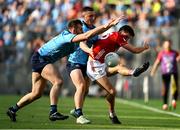 21 June 2025; Chris Óg Jones of Cork in action against Sean MacMahon, left, and John Small of Dublin during the GAA Football All-Ireland Senior Championship preliminary quarter-final match between Dublin and Cork at Croke Park in Dublin. Photo by Daire Brennan/Sportsfile